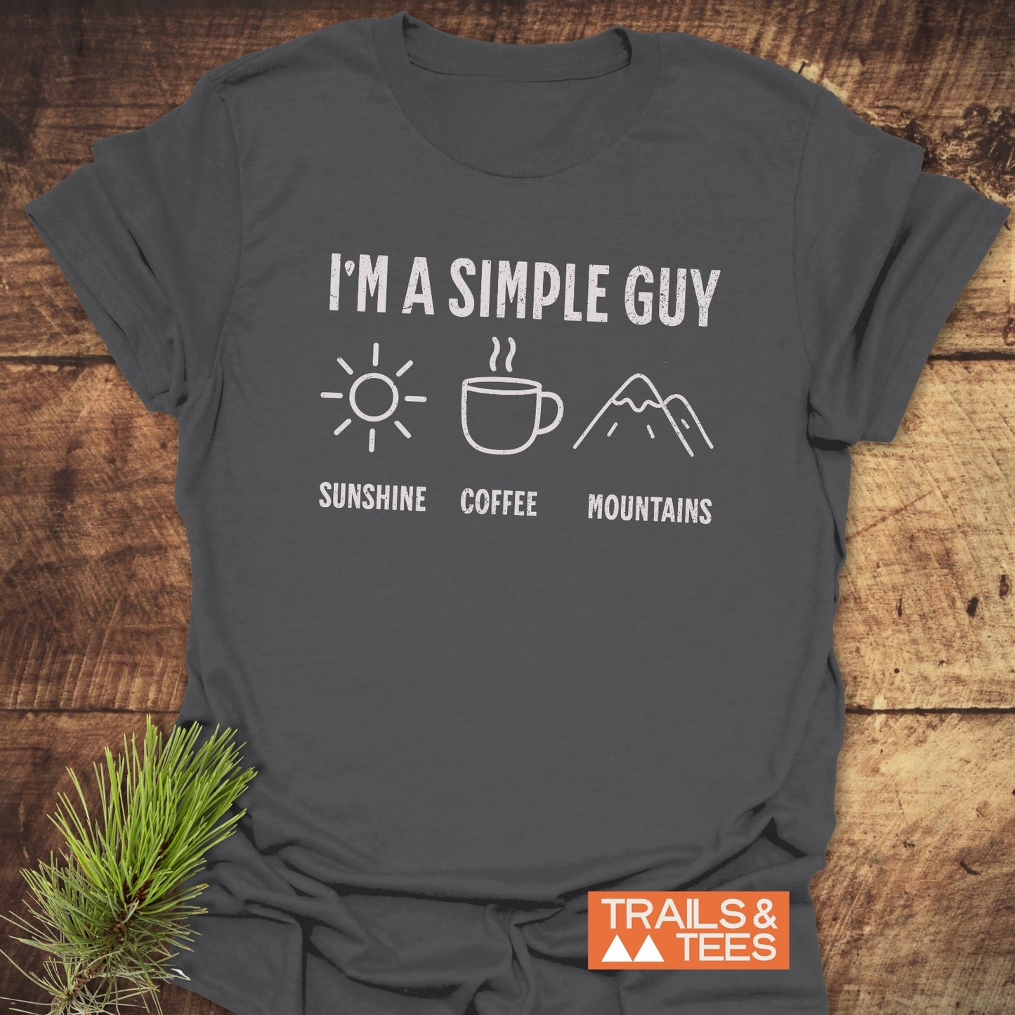 Grey t-shirt featuring the I'm A Simple Guy - Sunshine Coffee Mountains text in white. Close-up highlights the shirt's casual, active-wear appeal.