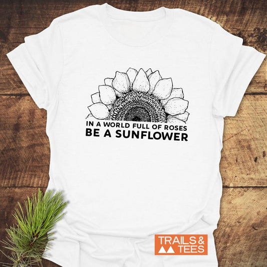 Be A Sunflower T-Shirt featuring a black and white sunflower drawing on a white shirt, emphasizing positivity and active lifestyle.