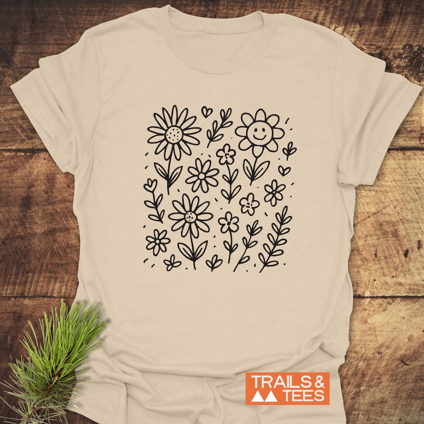 Wildflower Smiles T-Shirt featuring a detailed drawing of flowers and leaves, ideal for casual wear.
