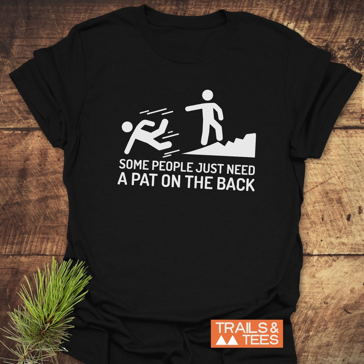 Black t-shirt featuring the text Some People Need A Pat On The Back in white, highlighting its bold statement design.