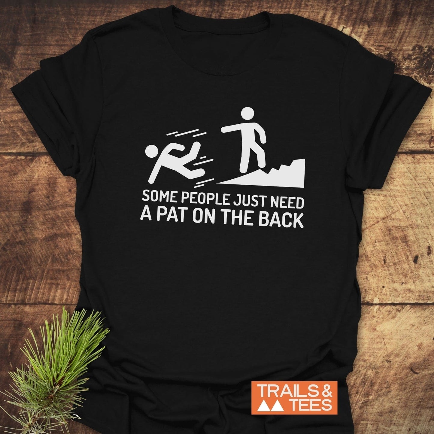 Black t-shirt featuring the text Some People Need A Pat On The Back in white, highlighting its bold statement design.