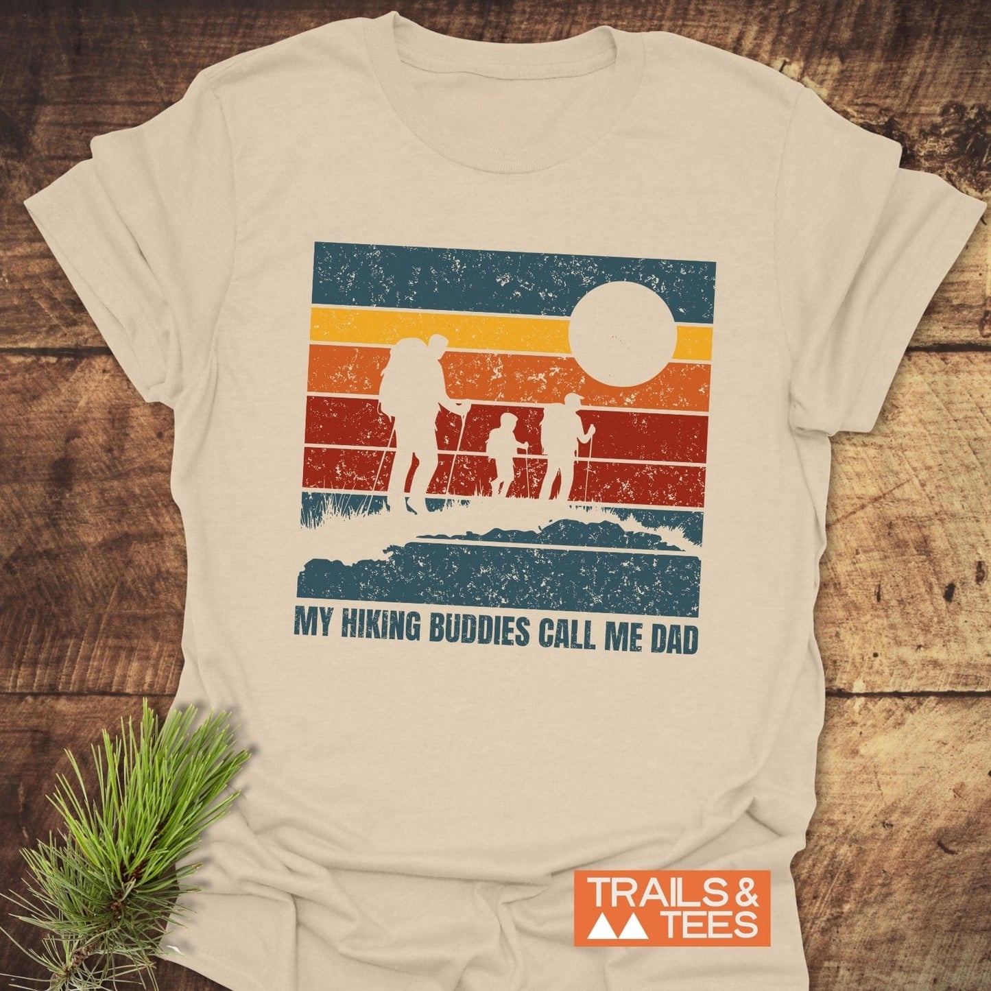 Group hiking scene featuring the My Hiking Buddies Call Me Dad T-Shirt, highlighting its active wear style with a person silhouetted against a nature backdrop.