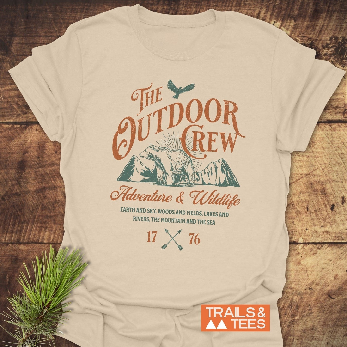 The Outdoor Crew Vintage T-Shirt on a table, showcasing its durable DTF prints and soft ring-spun cotton, designed for outdoor enthusiasts.