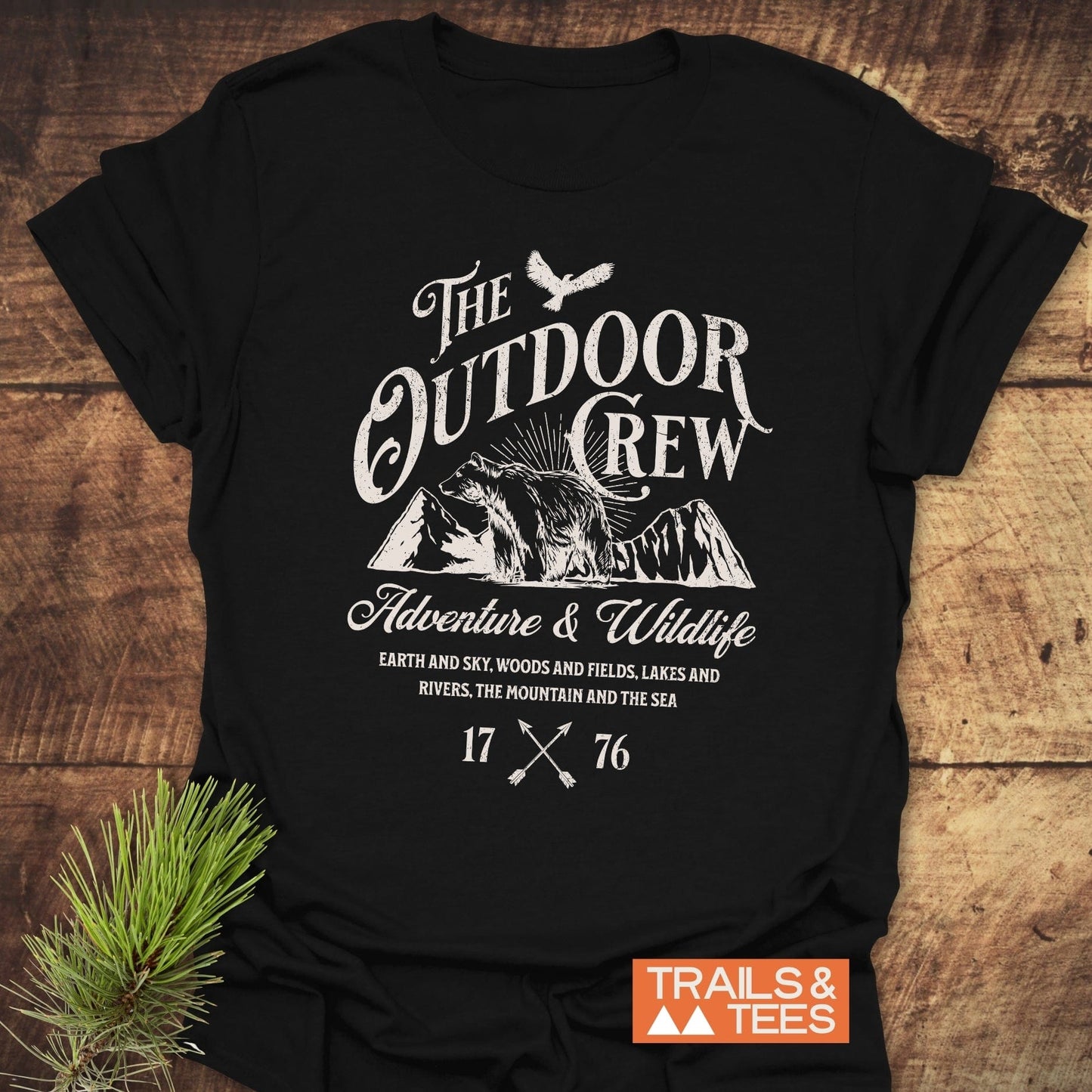 The Outdoor Crew Vintage T-Shirt features durable white text on a black shirt, crafted for comfort with no side seams and taped shoulders.