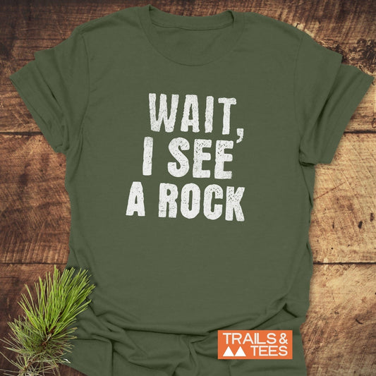 Wait, I See A Rock T-Shirt featuring white text on a green background, crafted from soft, lightweight cotton for comfort and durability in outdoor adventures.
