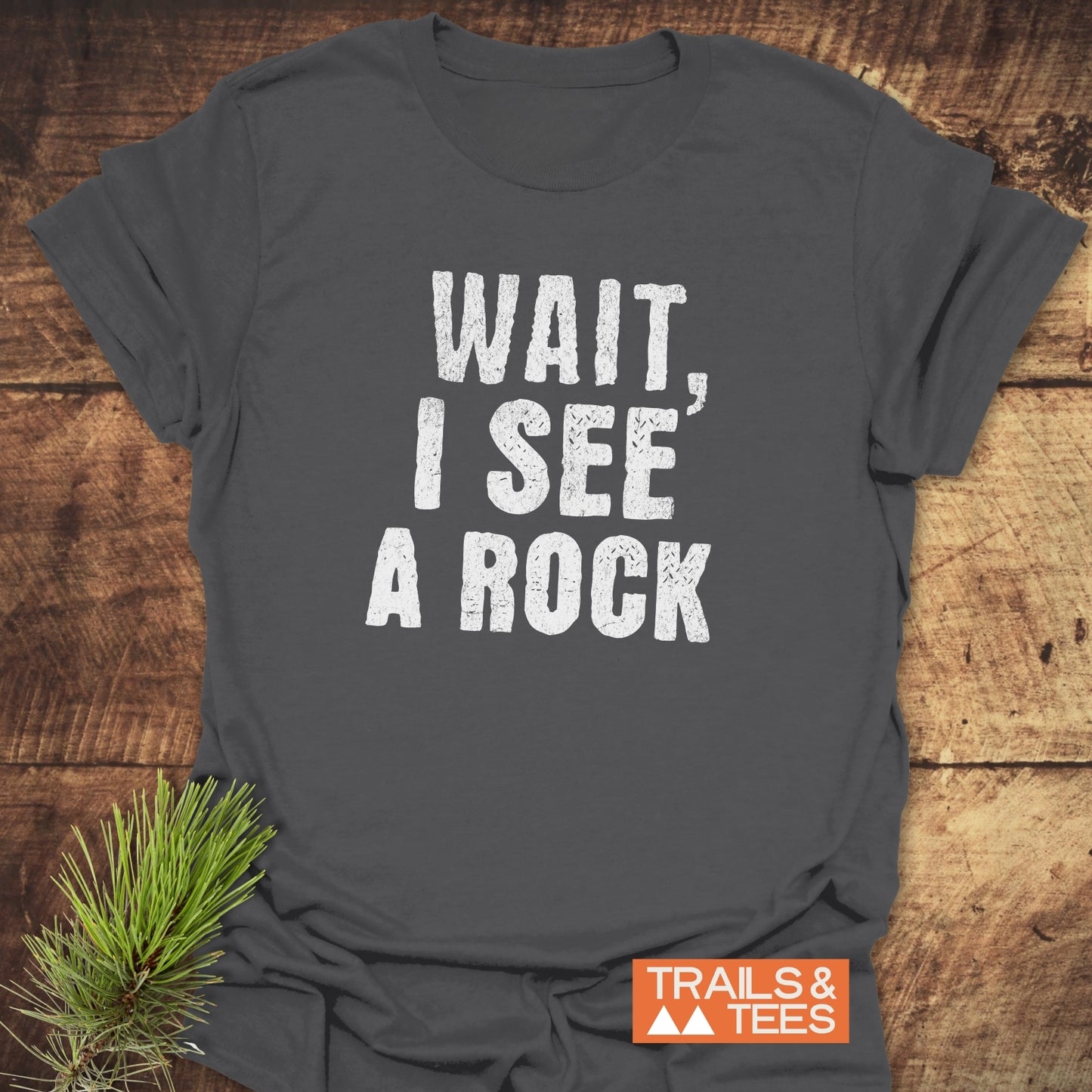 Wait, I See A Rock T-Shirt: Soft, lightweight tee with white text, perfect for outdoor adventures. Durable design, pre-shrunk, and printed on demand in the USA.