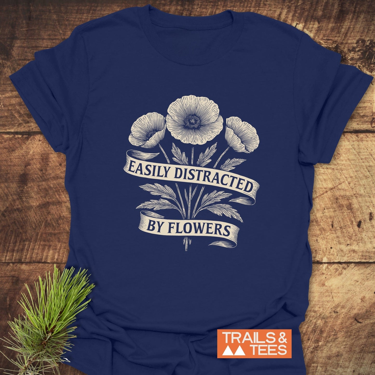 Easyly Distracted By Flowers T-Shirt featuring white floral pattern on a blue, ring-spun cotton fabric, designed for comfort and durability in outdoor adventures.