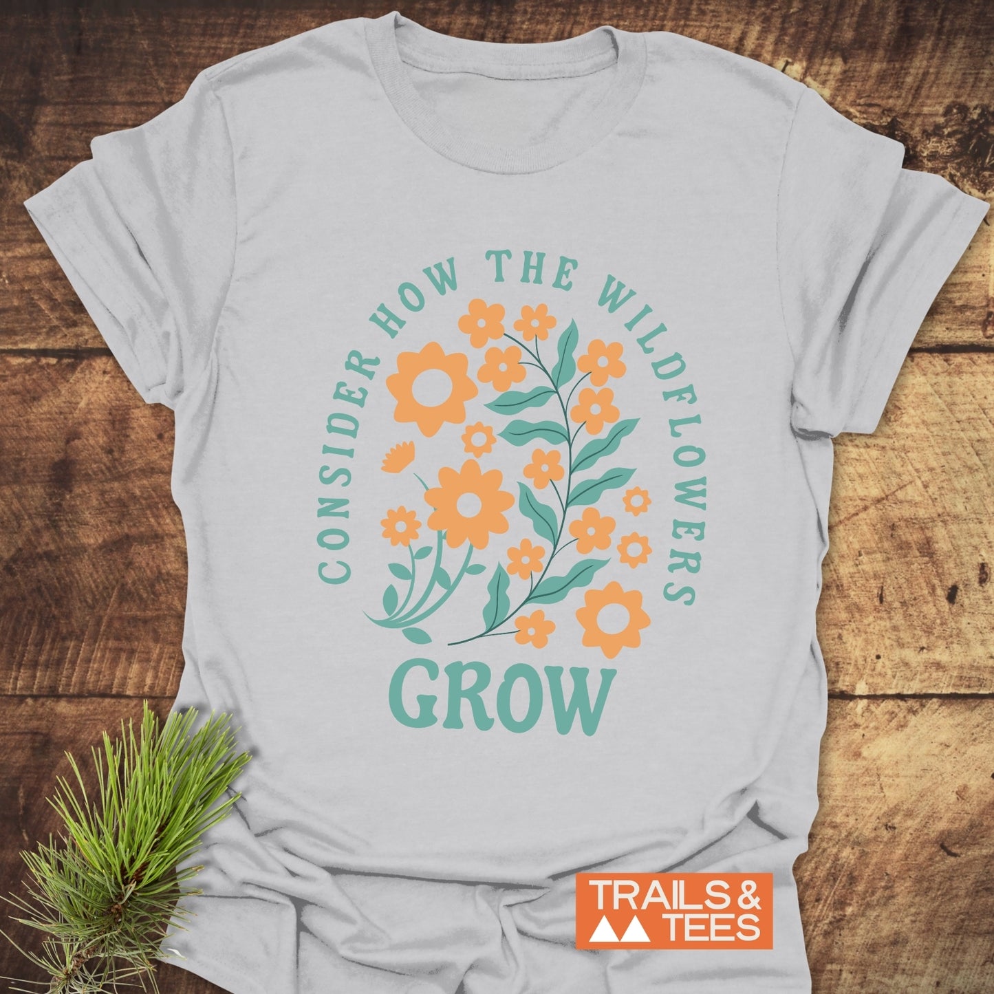 Wildflowers Luke 12:27 T-Shirt close-up, showcasing durable DTF prints on soft ring-spun cotton, designed for comfort and outdoor adventure enthusiasts.