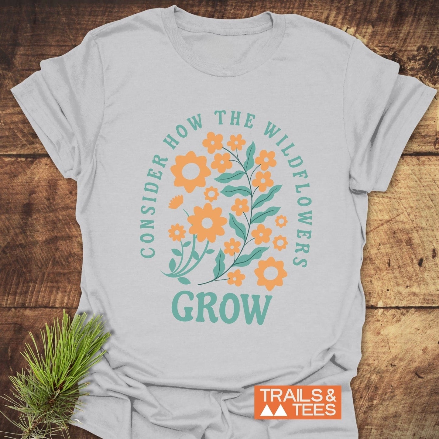 Wildflowers Luke 12:27 T-Shirt close-up, showcasing durable DTF prints on soft ring-spun cotton, designed for comfort and outdoor adventure enthusiasts.