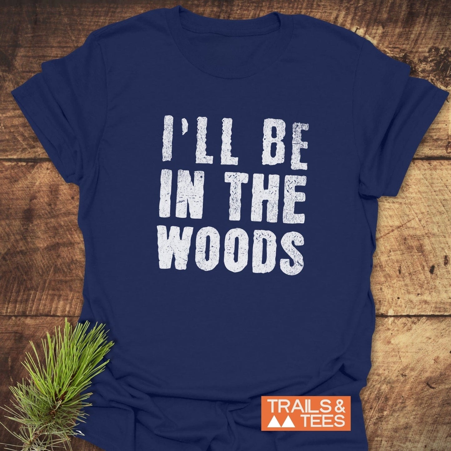 I'll Be In The Woods T-Shirt featuring white text on a blue shirt, crafted from soft, lightweight cotton for comfort and durability.