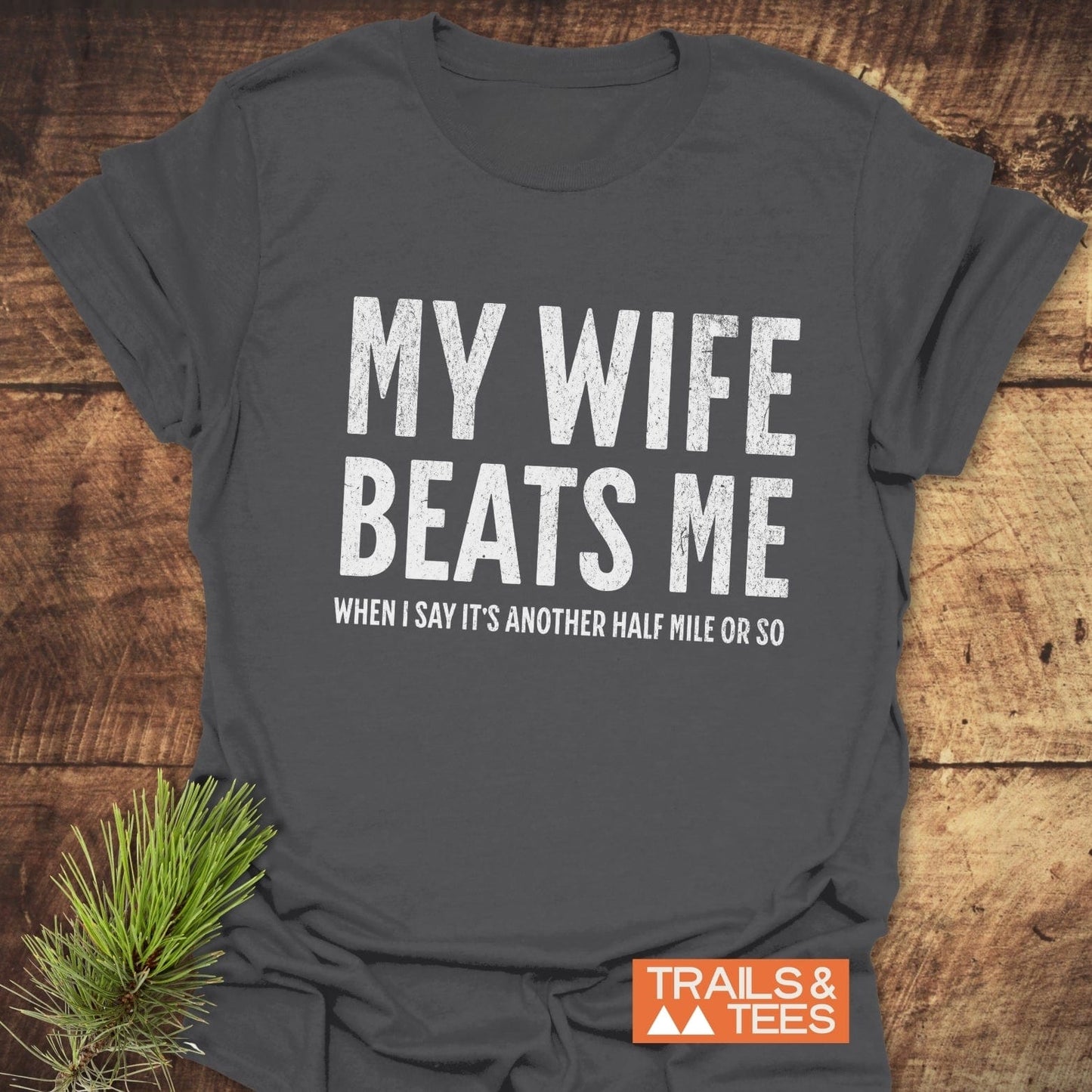 Grey My Wife Beats Me T-Shirt with durable white text, crafted from soft cotton for everyday outdoor adventures. Pre-shrunk, no side seams, printed on demand.