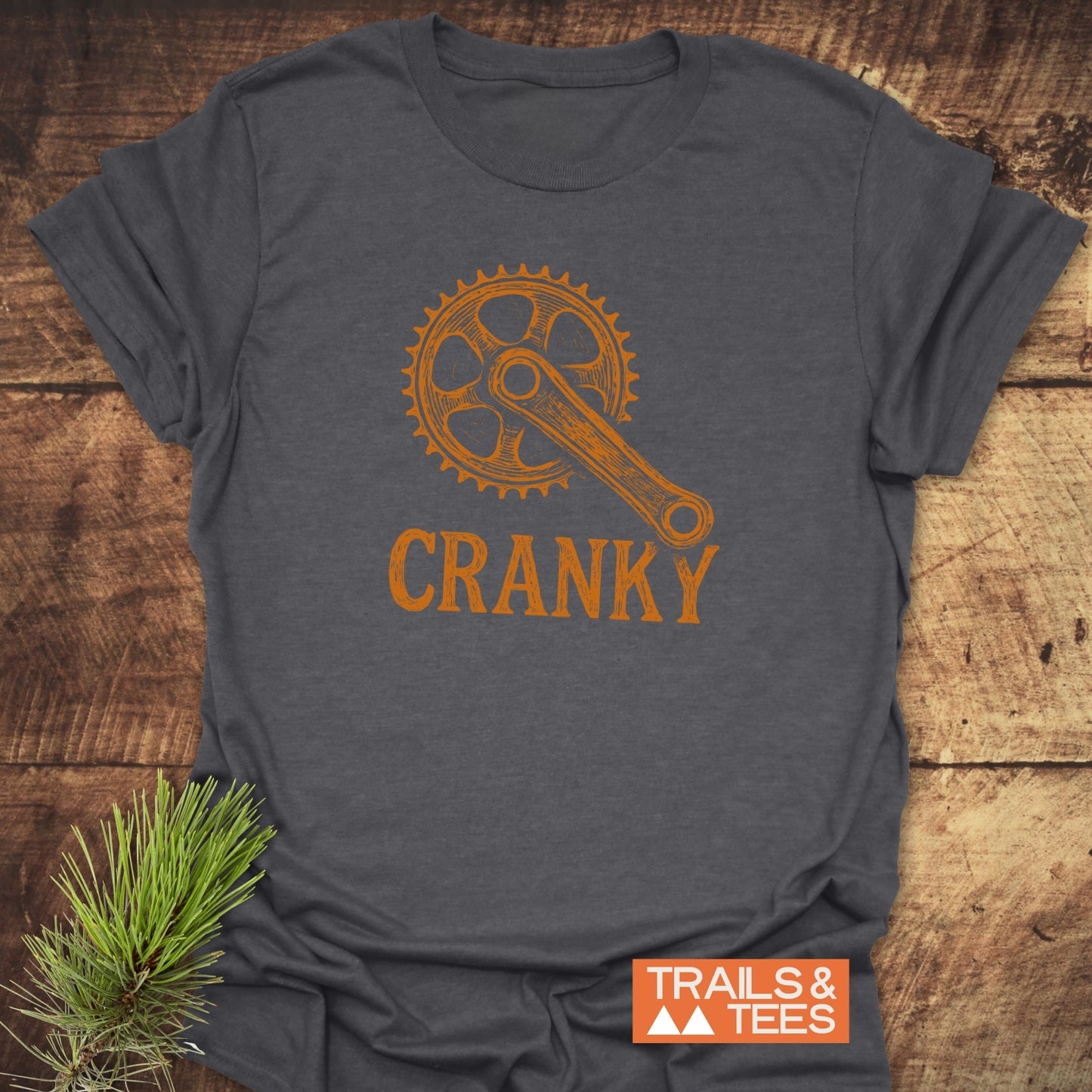 CRANKY T-Shirt featuring a dynamic orange design, showcasing its short sleeves and active wear style in a close-up view.
