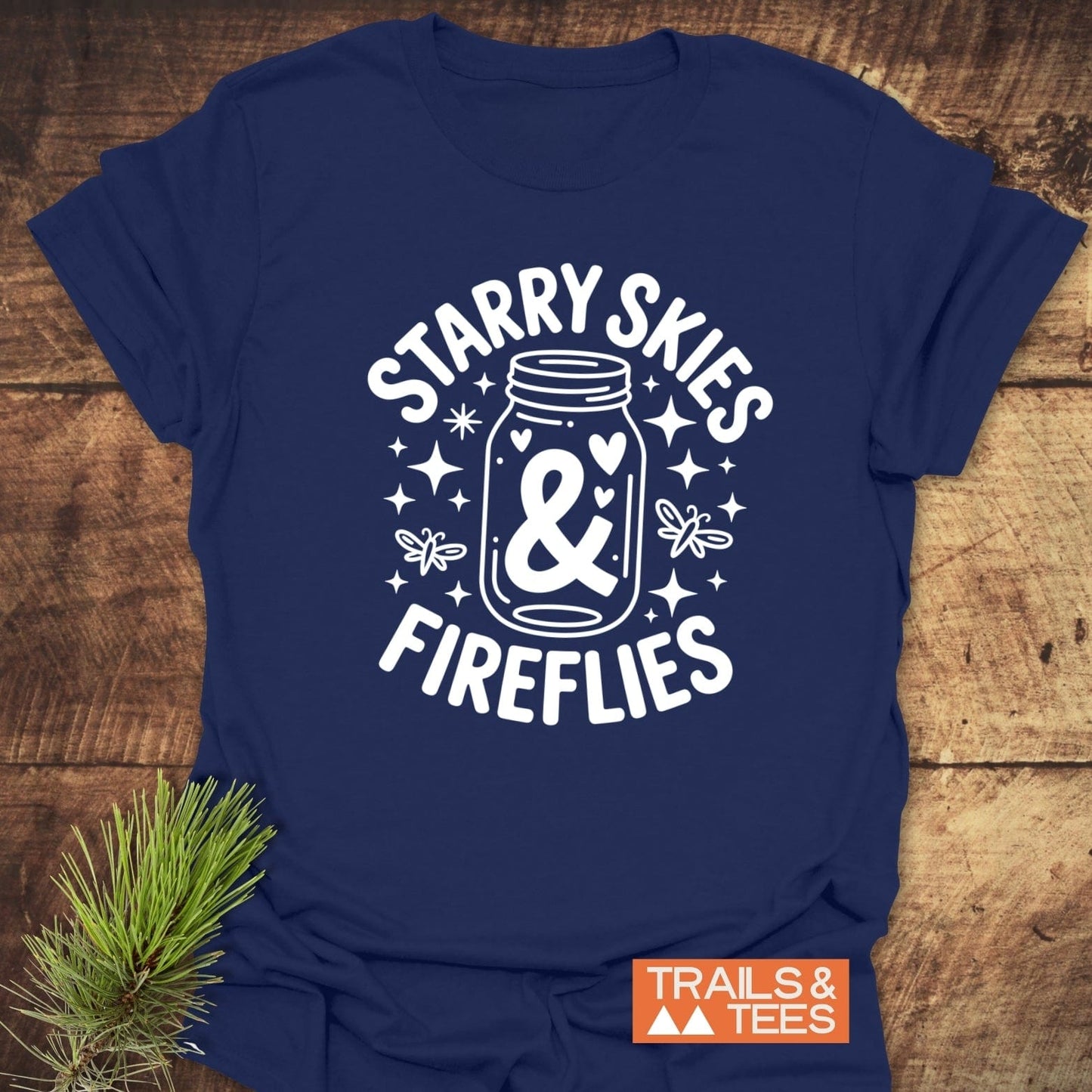 Starry Skies & Fireflies T-Shirt featuring a close-up logo on a blue shirt with prominent white text, ideal for active wear.