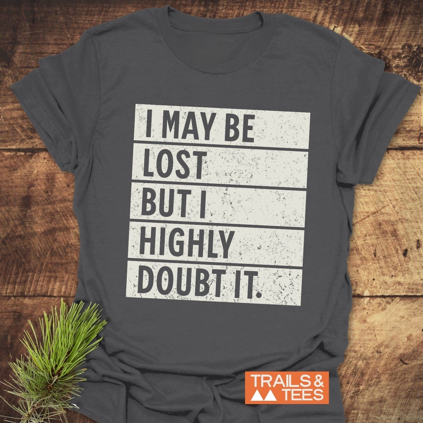 I May Be Lost But I Highly Doubt It T-Shirt with bold black lettering on a white background, showcasing a playful and confident statement.