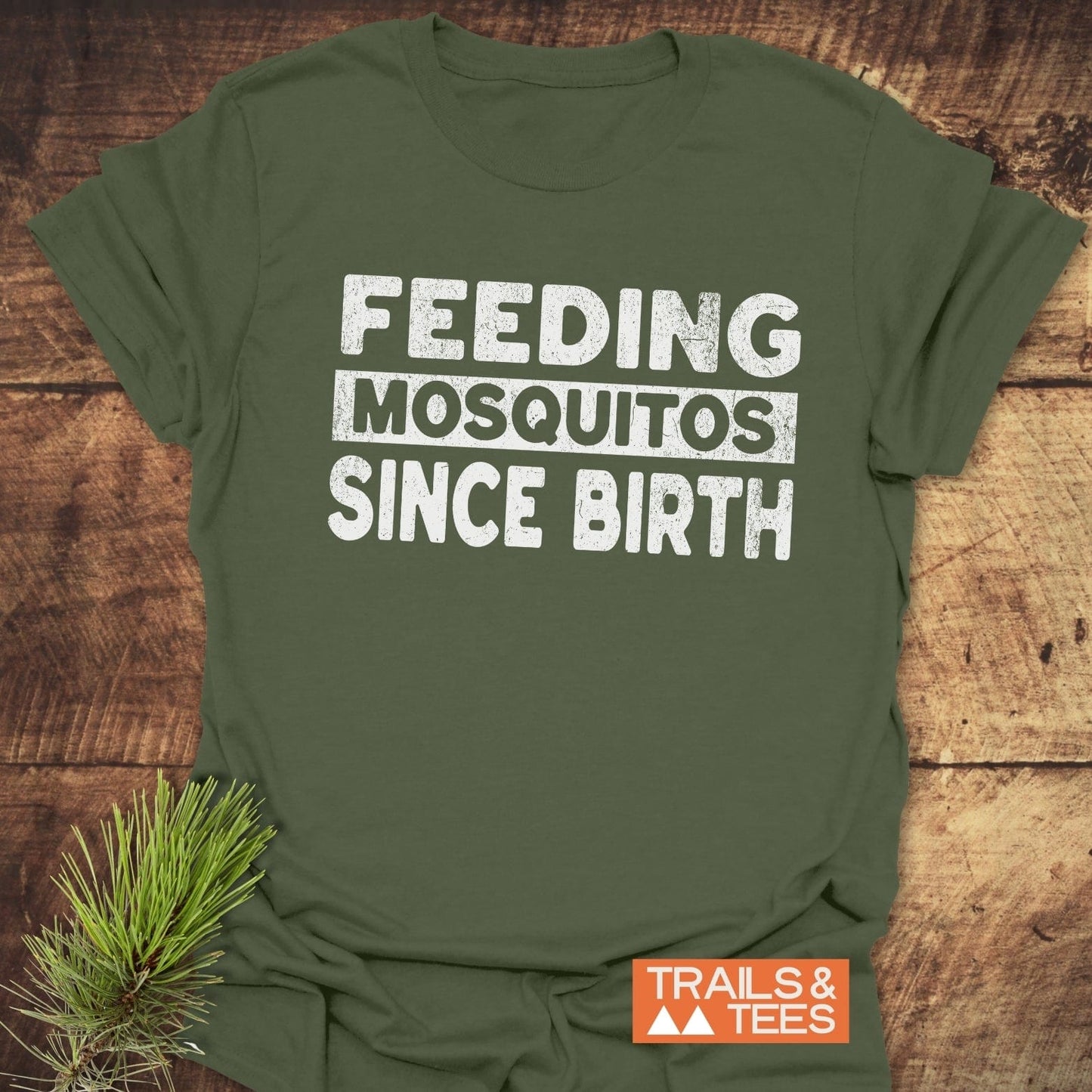 Feeding Mosquitos T-Shirt featuring white text on green fabric, crafted from soft cotton for comfort and durability, ideal for outdoor enthusiasts.