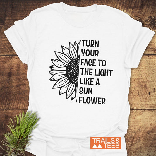 Turn Your Face To The Light T-Shirt featuring a sunflower design, crafted from soft ring-spun cotton, offering comfort and durability for outdoor adventures.