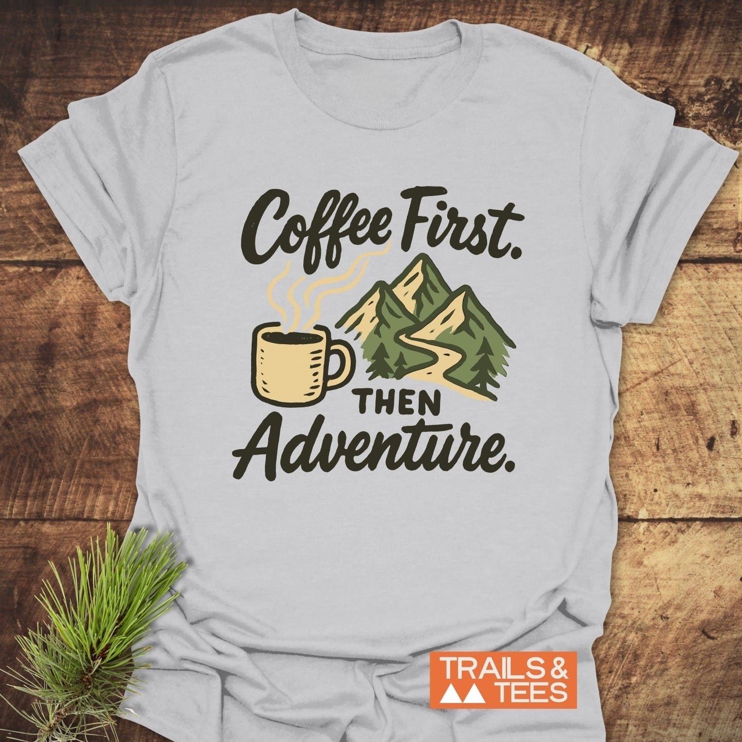 Coffee First Then Adventure T-Shirt featuring a mountain and coffee cup design, crafted from soft, lightweight cotton for comfort and durability, ideal for outdoor enthusiasts.
