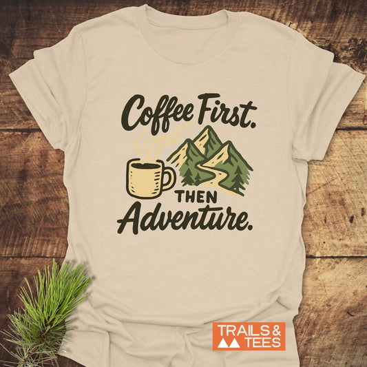 Close-up of the Coffee First Then Adventure T-Shirt, featuring durable prints on soft ring-spun cotton, ideal for outdoor enthusiasts.