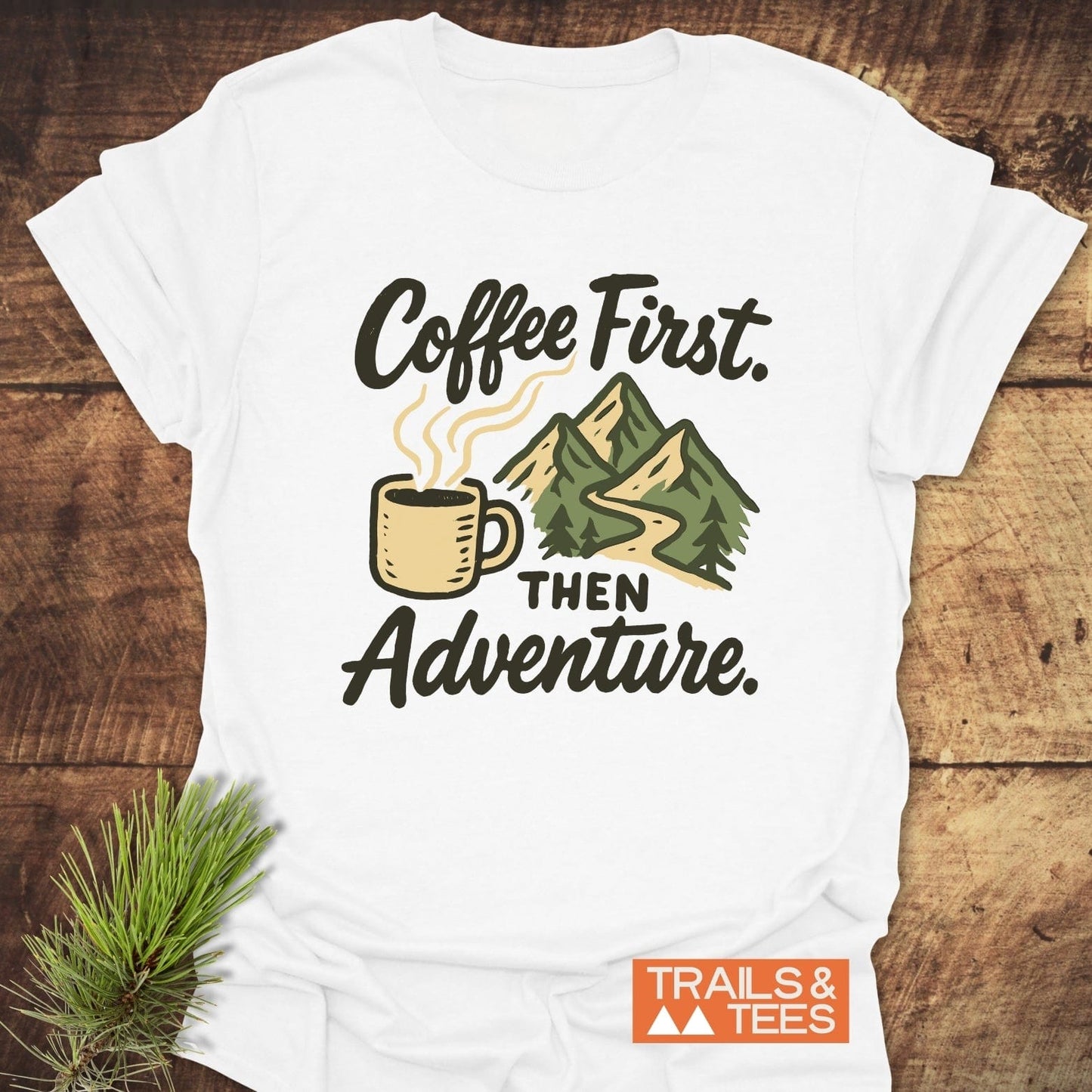 Coffee First Then Adventure T-Shirt featuring mountain and coffee cup graphic, crafted from soft cotton for comfort and durability, ideal for outdoor enthusiasts.