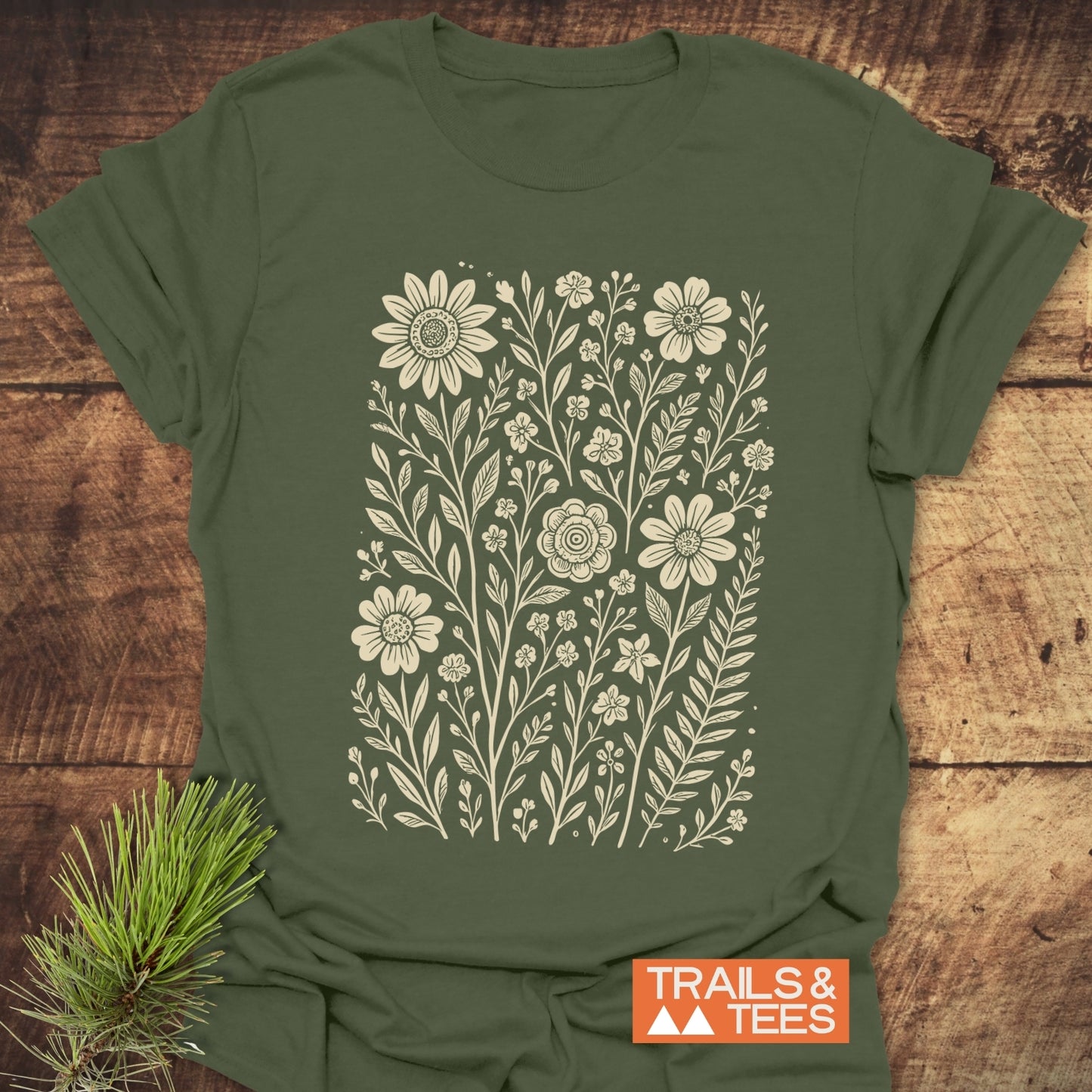 Wild Flowers T-Shirt featuring a green base with white floral pattern, crafted from soft ring-spun cotton for comfort and durability, perfect for outdoor adventures.