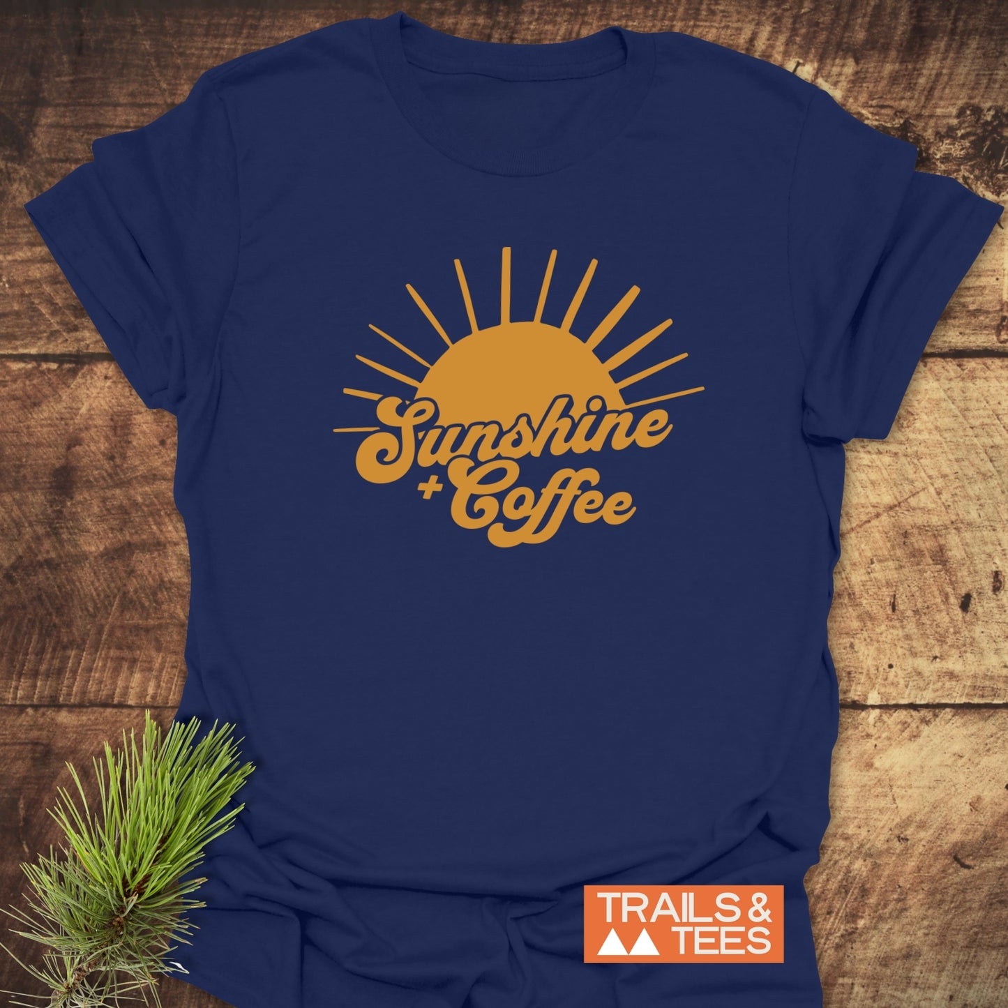 Sunshine And Coffee T-Shirt featuring a blue design with a yellow sun and text, crafted for comfort and outdoor enthusiasts. Perfect for everyday adventures.