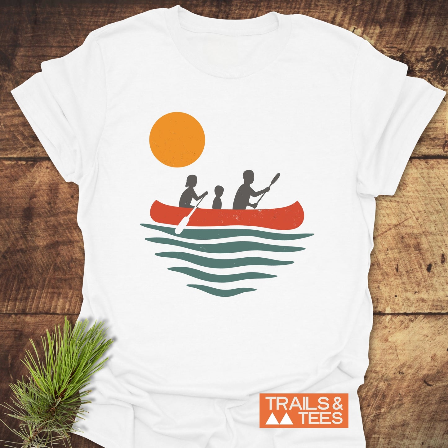 Family Canoe T-Shirt featuring a silhouette of a boy with a paddle and people in a canoe, crafted for outdoor enthusiasts from ring-spun cotton.