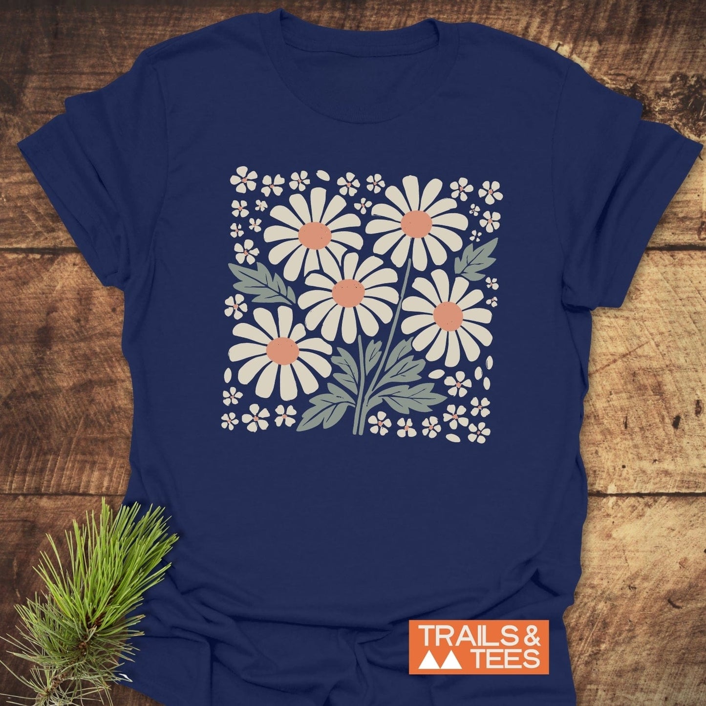 Retro Daisy Love T-Shirt featuring white floral design on blue, crafted from soft, lightweight cotton for comfort. Ideal for outdoor adventures.