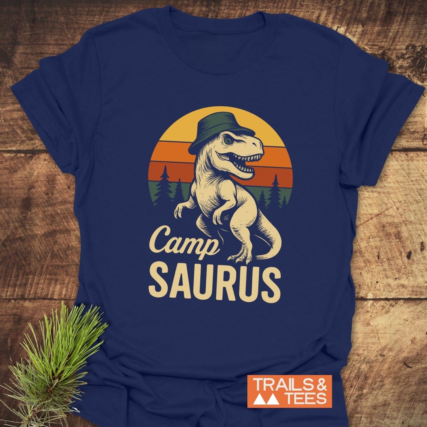 CampSaurus T-Shirt featuring a cartoon dinosaur in a hat, crafted for comfort with durable prints and pre-shrunk, ideal for outdoor adventures.
