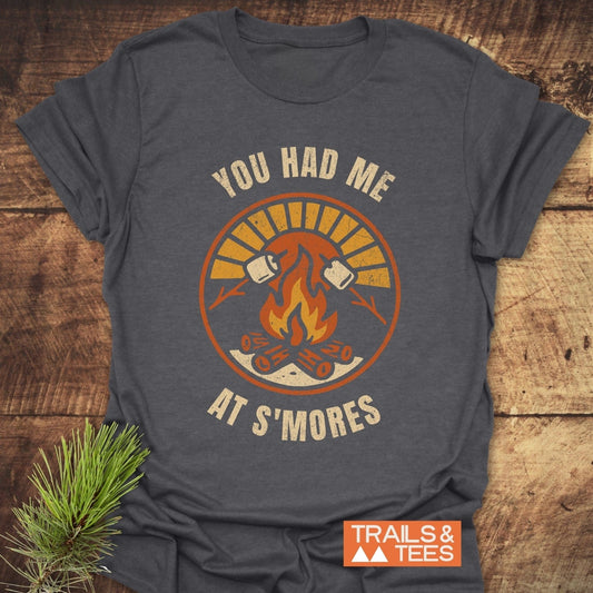 You Had Me At S'mores T-Shirt featuring a campfire and marshmallows graphic, highlighting its soft, durable, and adventure-ready design.