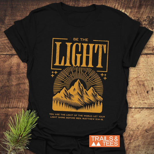 Be The Light, Matthew 5:14-16 T-Shirt featuring durable yellow text on a soft, lightweight, pre-shrunk black cotton tee, designed for comfort and outdoor adventures.