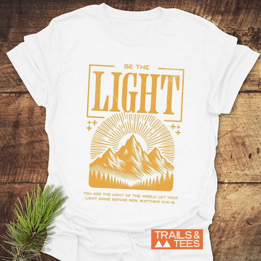 Be The Light, Matthew 5:14-16 T-Shirt featuring gold text, crafted from soft, lightweight cotton for everyday adventures. Durable print and pre-shrunk for a reliable fit.