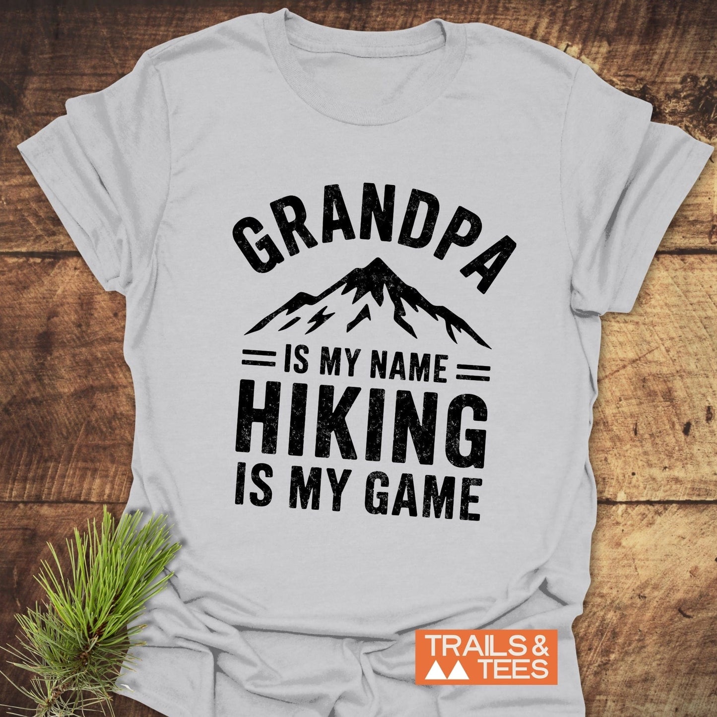 Grandpa Is My Name Hiking Is My Game T-Shirt featuring bold black text on a white t-shirt, designed for outdoor enthusiasts.