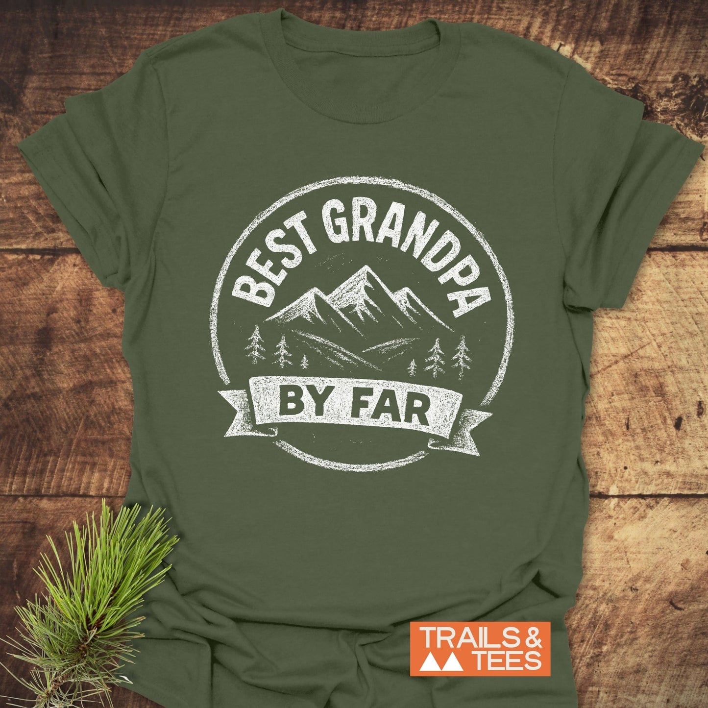 Best Grandpa By Far T-Shirt with mountain and pine graphic, featuring durable print and soft ring-spun cotton, styled with pine sprig.