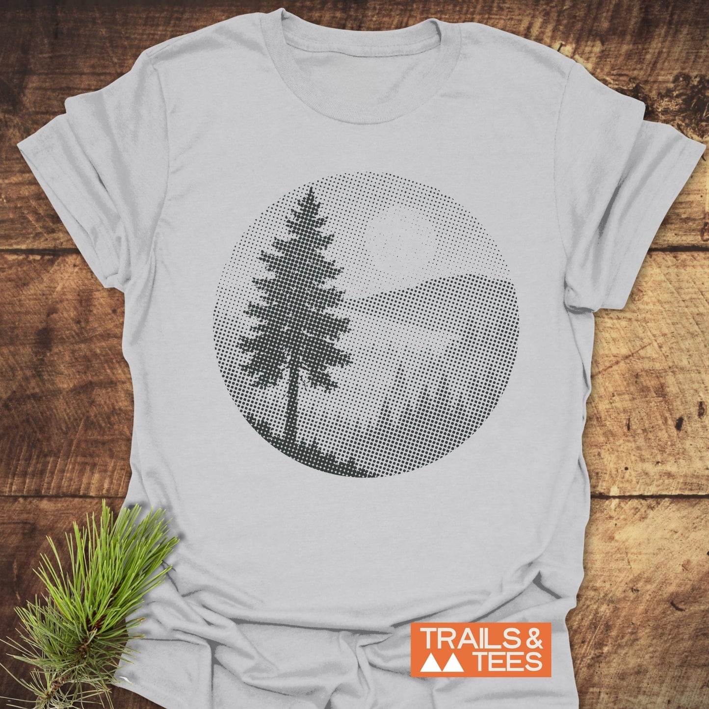 Sunset Woods Halftone T-Shirt featuring a lone pine tree graphic, crafted from lightweight cotton for comfort. Includes durable print, pre-shrunk fit, and eco-friendly production.