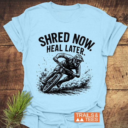 Shred Now Heal Later Mountainbike T-Shirt featuring a man riding a bike, crafted from soft cotton for comfort and durability, ideal for outdoor enthusiasts.