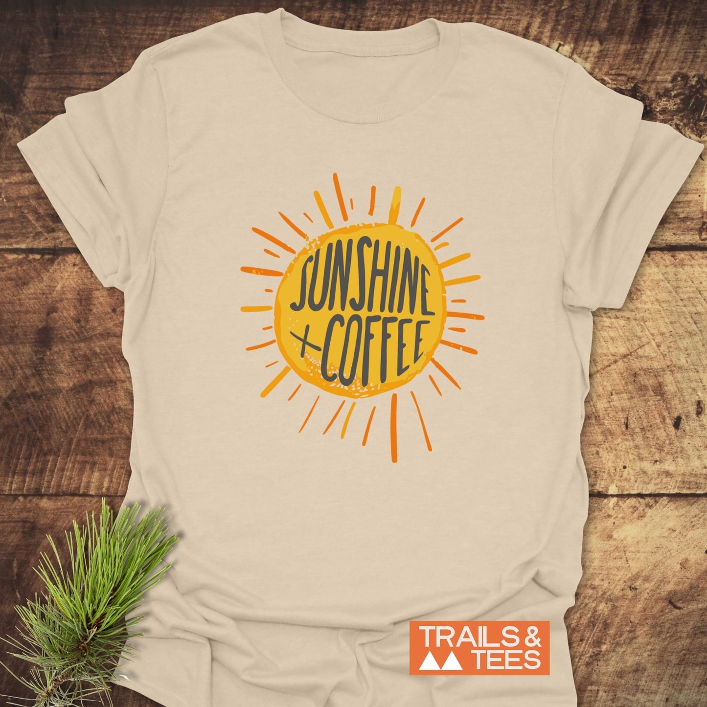Sunshine + Coffee T-Shirt featuring a hand-drawn sun graphic; crafted from soft ring-spun cotton, perfect for adventures or casual outdoor wear.