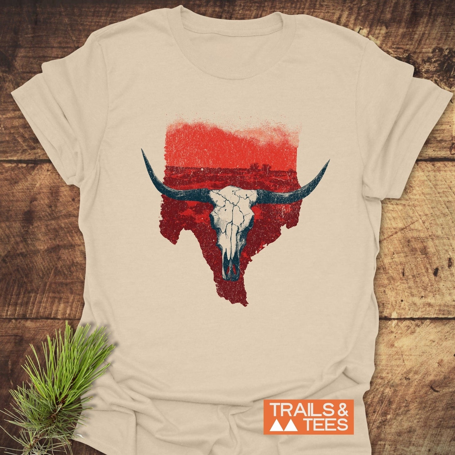 Hike Texas T-Shirt with a longhorn skull and Texas graphic on soft cotton, styled with a pine sprig, ideal for outdoor adventures.