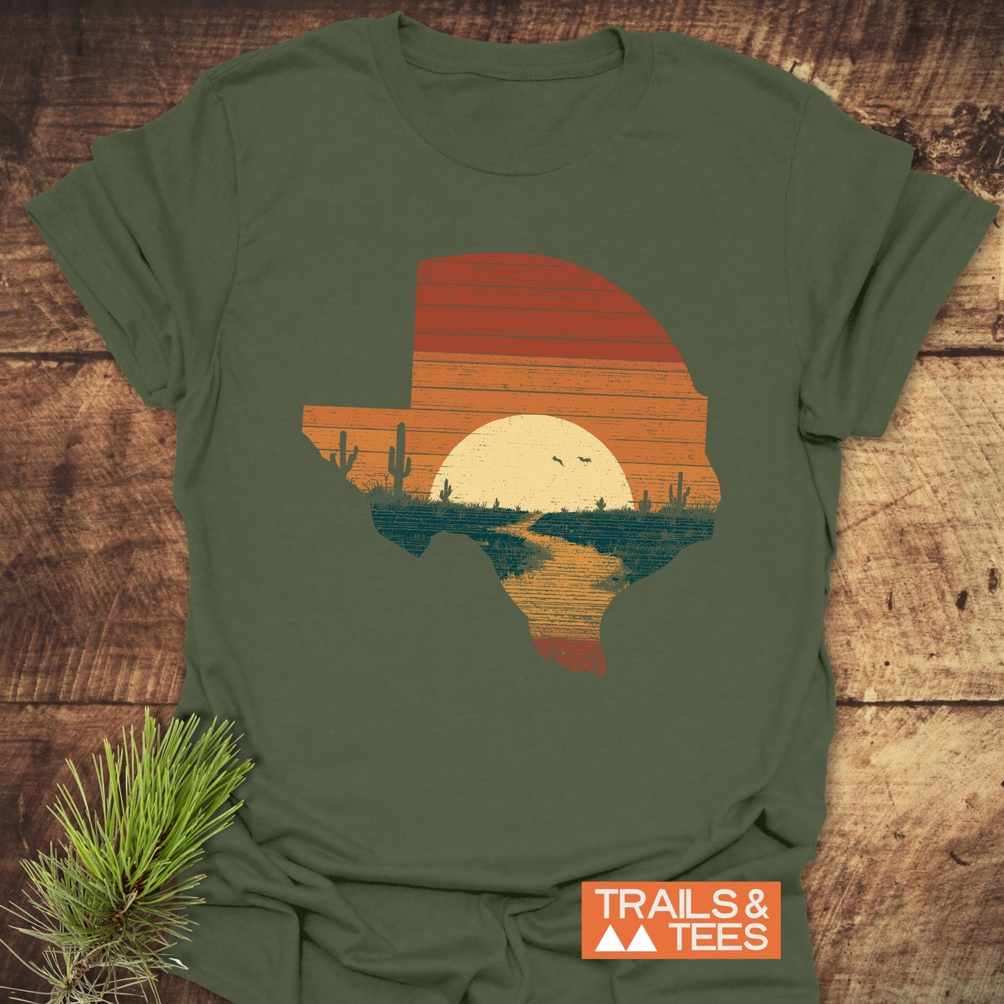 Texas Sunset T-Shirt featuring a retro Texas graphic with a desert sunset scene, crafted from soft, lightweight cotton for comfort and durability by Trails & Tees.