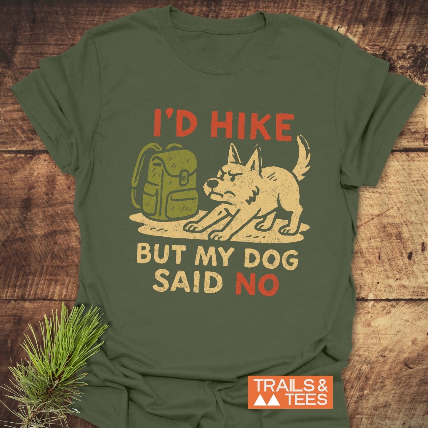 Dog Stops The Hike T-Shirt with a dog and backpack graphic, featuring “I’D HIKE BUT MY DOG SAID NO” text. Made from soft, durable cotton.