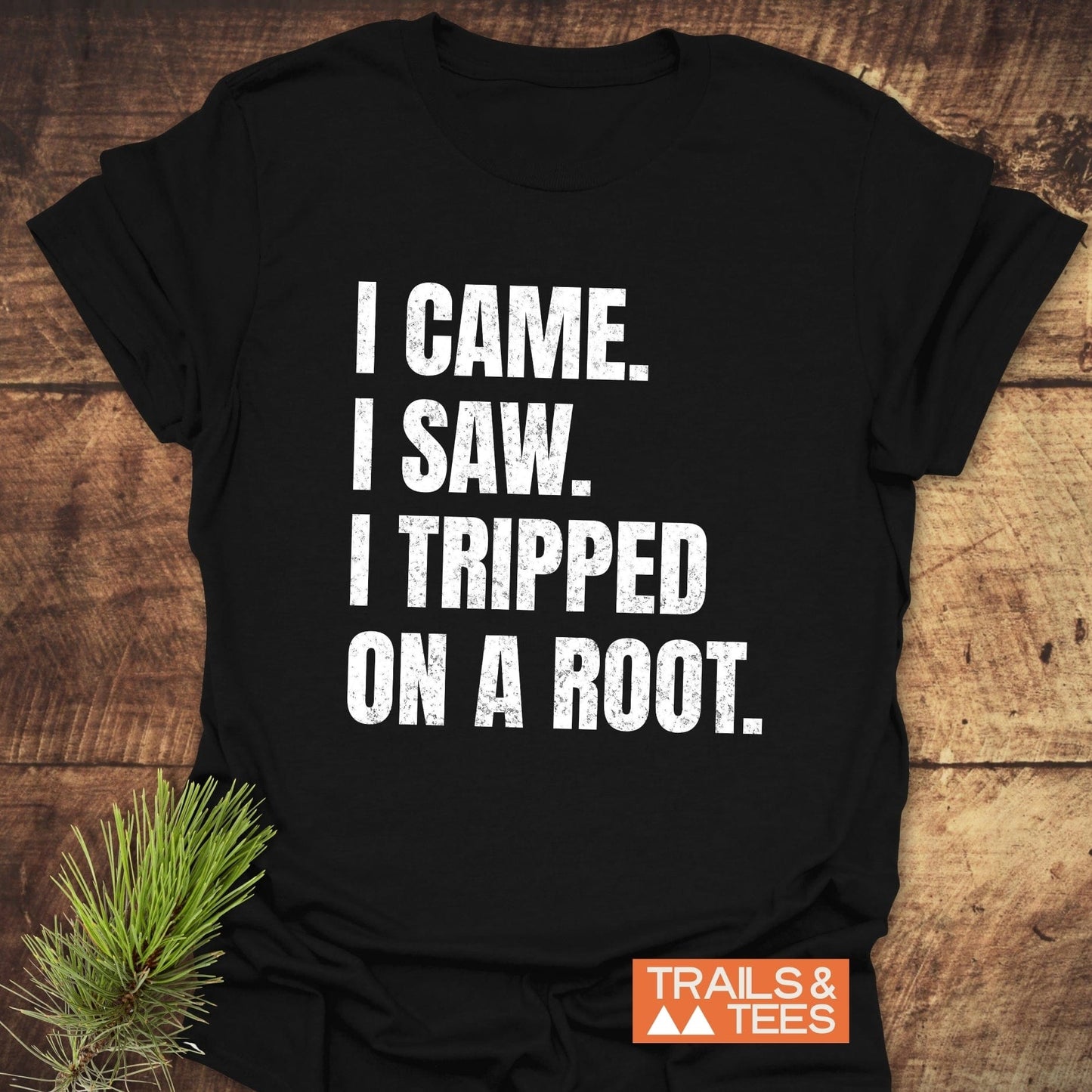 Black I Came. I Saw. I Tripped... T-shirt with distressed white text, orange TRAILS & TEES logo; soft ring-spun cotton, ideal for outdoor enthusiasts.