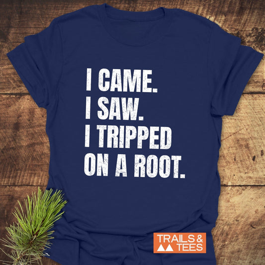 Navy-blue I Came. I Saw. I Tripped... T-Shirt with distressed white lettering on rustic wood, featuring a small TRAILS & TEES logo.