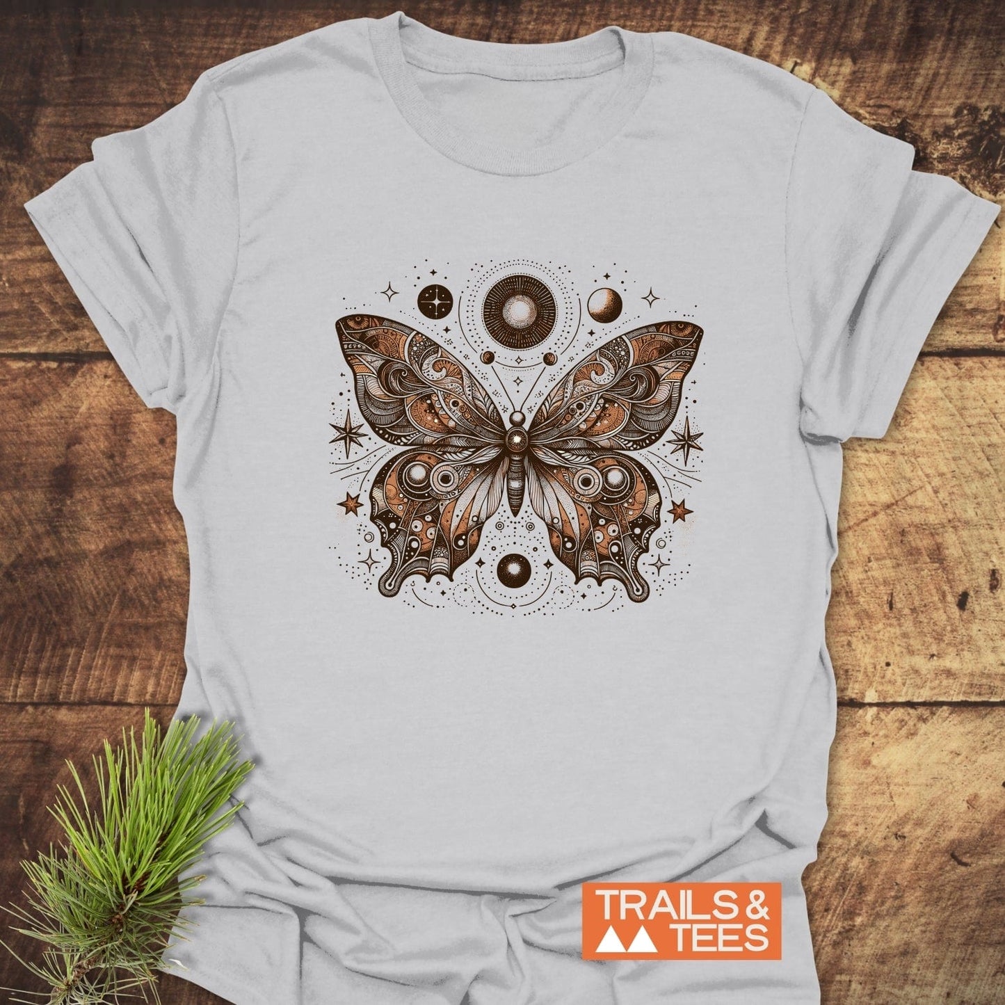 Celestial Butterfly T-Shirt featuring a coppery ornamental butterfly with celestial motifs, crafted from soft, lightweight cotton for trail-tested comfort and durability.