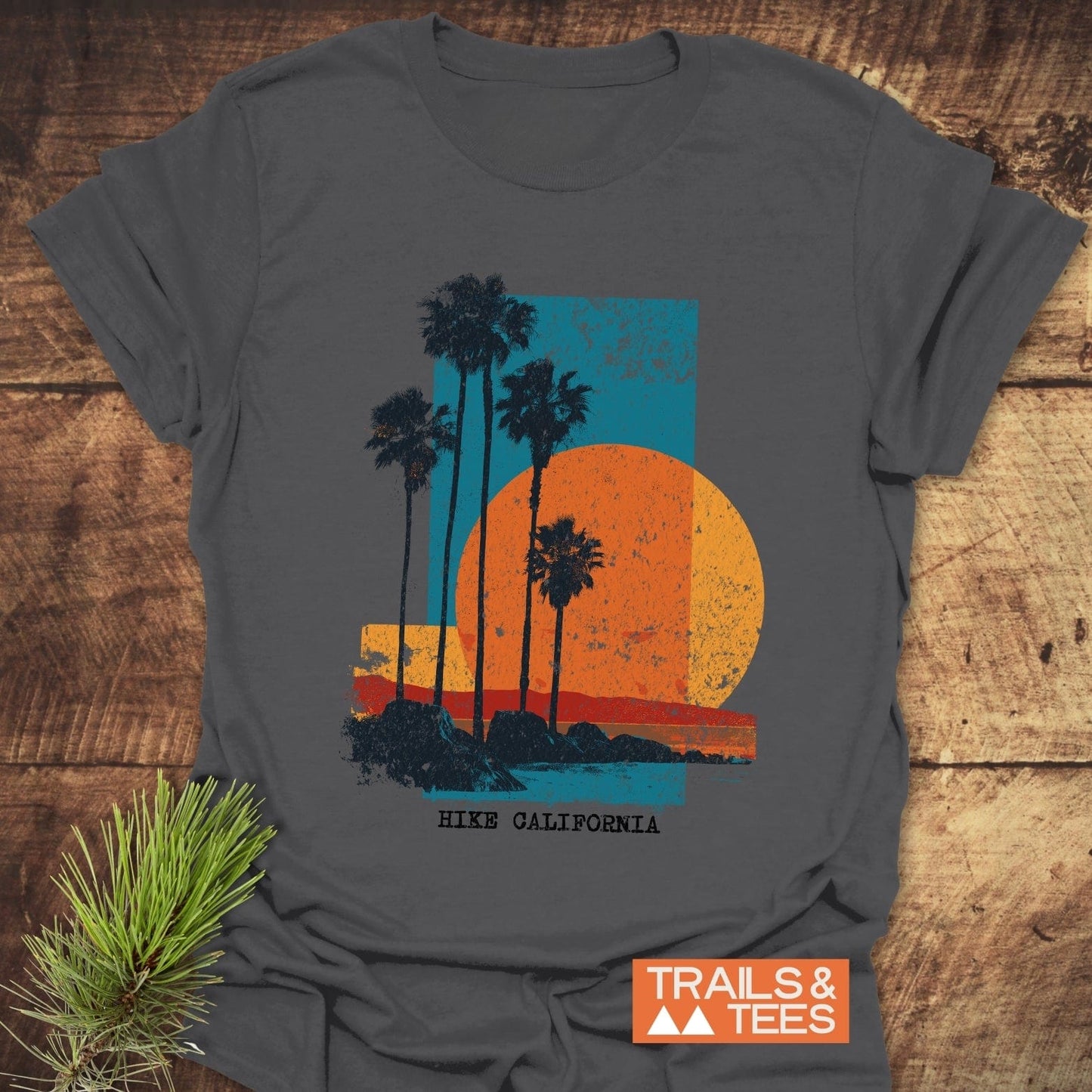 Hike California T-Shirt featuring a vintage coastal graphic with palm trees, a sun, and shoreline. Made from soft, lightweight cotton for everyday outdoor adventures.