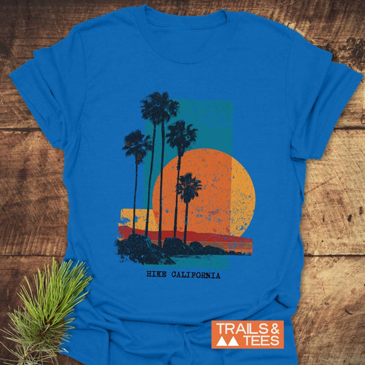 Hike California T-Shirt featuring retro palm trees and sun graphic, made from soft, ring-spun cotton, designed for comfort and everyday outdoor adventures.