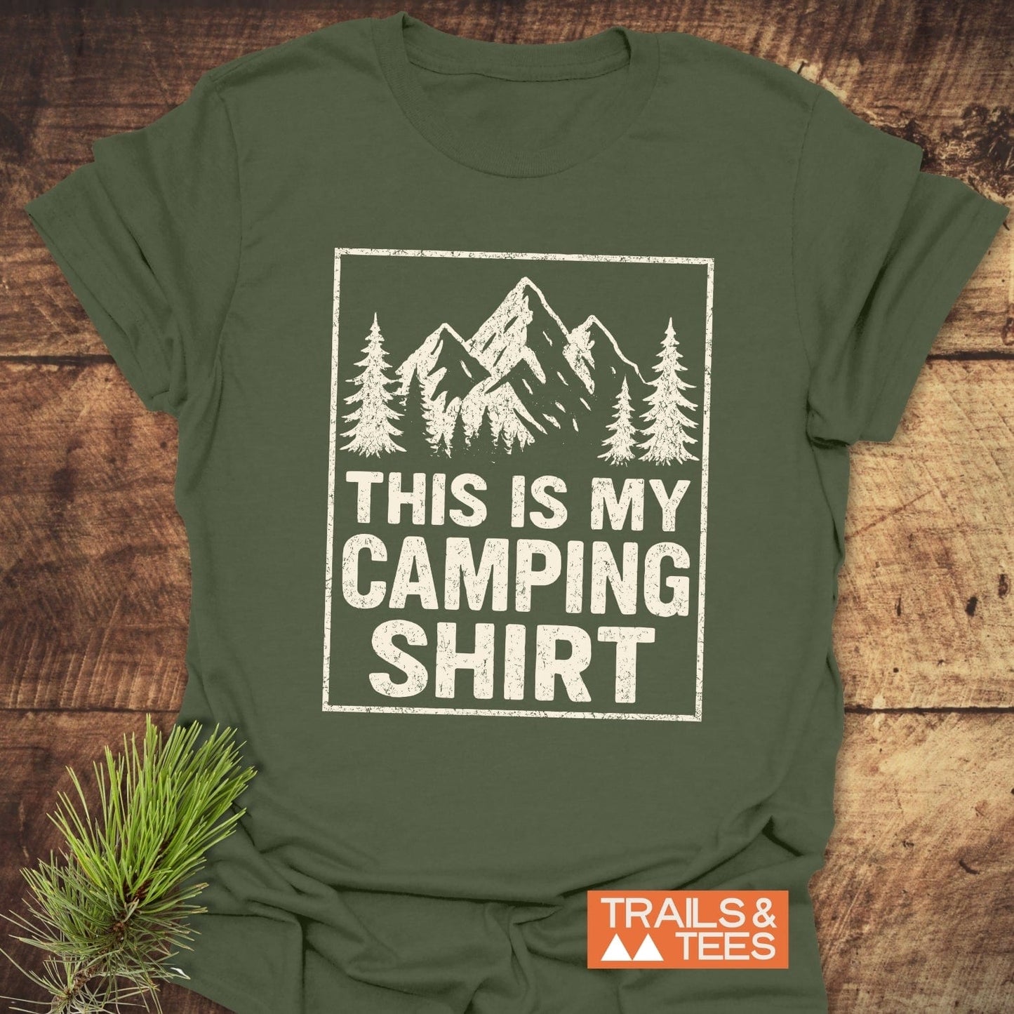 This Is My CAMPING T-Shirt features stylized trees and mountains, perfect for outdoor enthusiasts. Made from soft ring-spun cotton for comfort and durability.