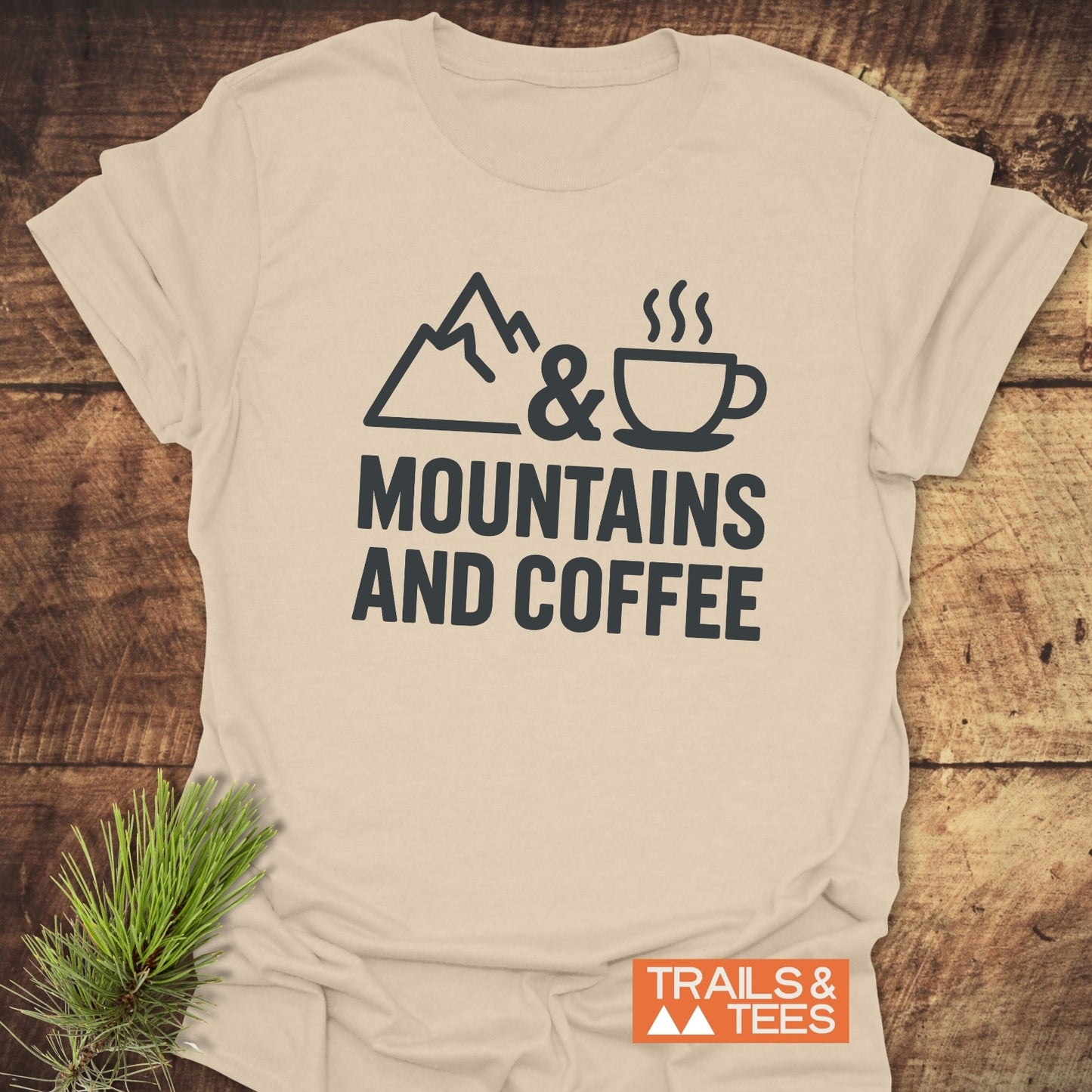 Mountains And Coffee T-Shirt featuring a mountain, ampersand, and coffee cup graphic, showcasing soft, durable cotton perfect for outdoor enthusiasts.