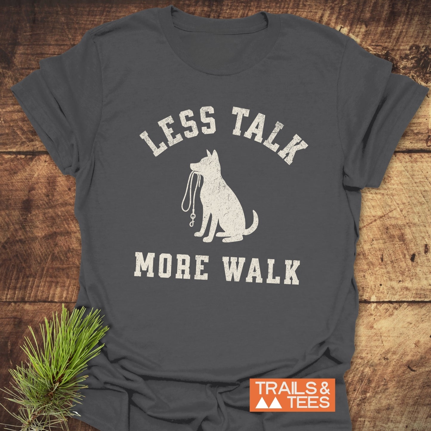 Less Talk, More Walk T-Shirt featuring a dog silhouette with leash. Made from soft cotton, pre-shrunk, durable print. Ideal for outdoor enthusiasts.