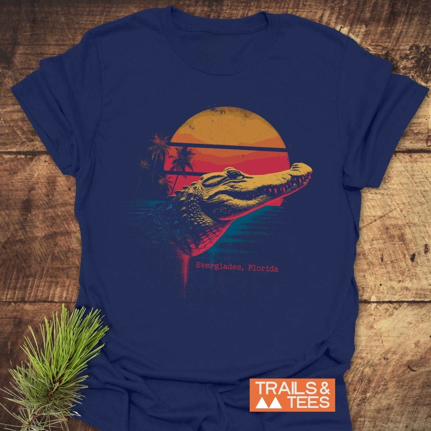 Everglades Alligator T-Shirt featuring a retro alligator graphic with sunset and palm trees. Made from soft, pre-shrunk cotton for comfort.