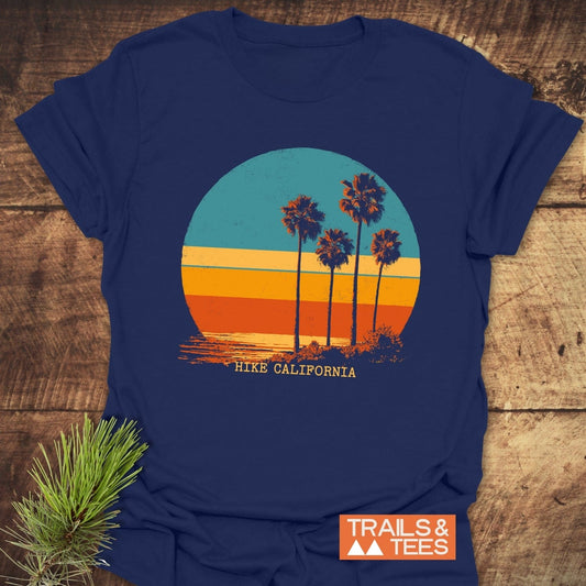 Hike California T-Shirt with retro sunset and palm trees graphic, crafted from soft cotton for comfort, featuring durable prints and taped shoulders for lasting shape.