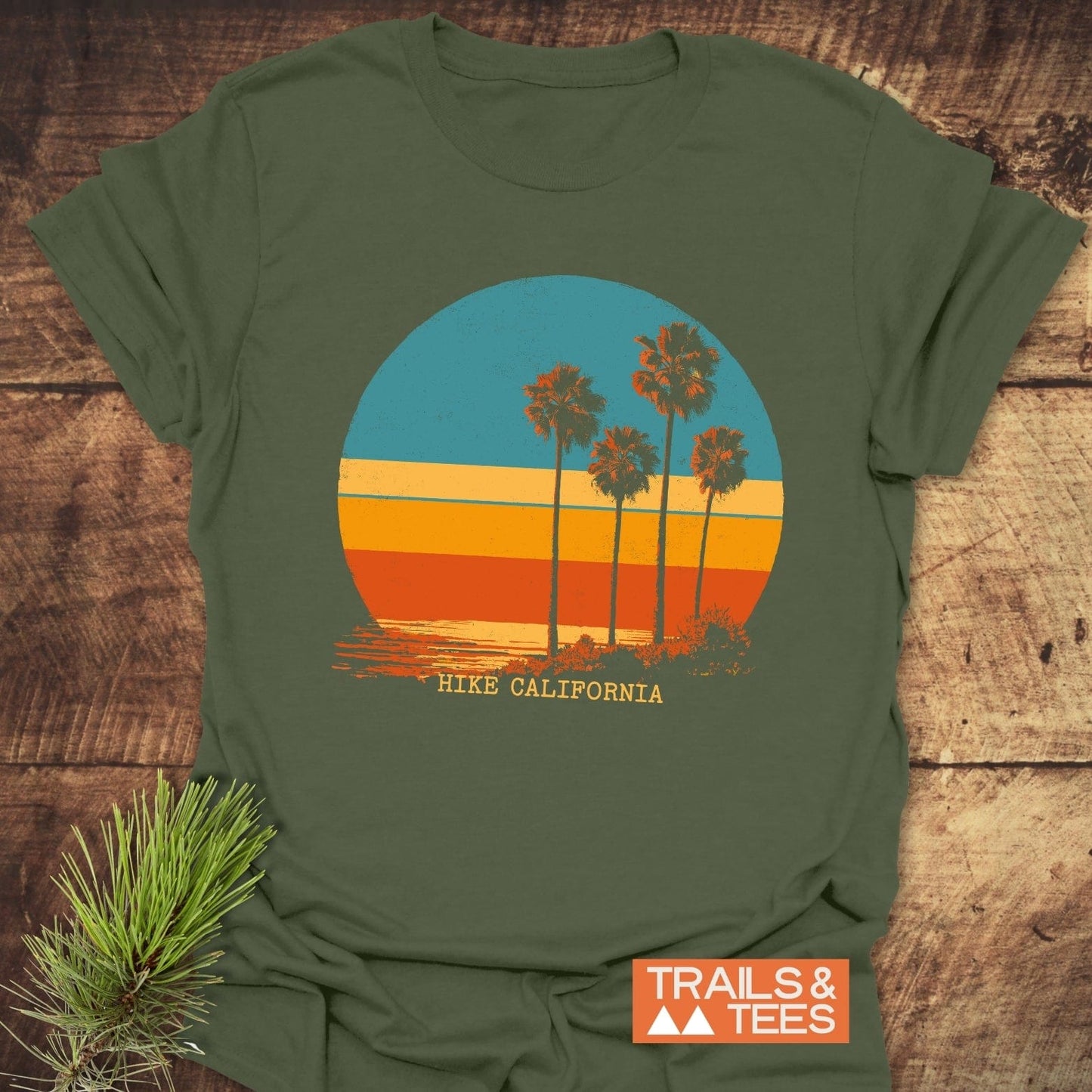 Hike California T-Shirt featuring a retro sunset graphic with palm-tree silhouettes, crafted from soft ring-spun cotton, ideal for outdoor adventures.